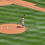 Aerial view of a baseball pitcher on the mound during a game in Seattle, WA under sunny skies.