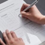 A close-up image of a hand marking an official election ballot with a pen, representing democratic voting.