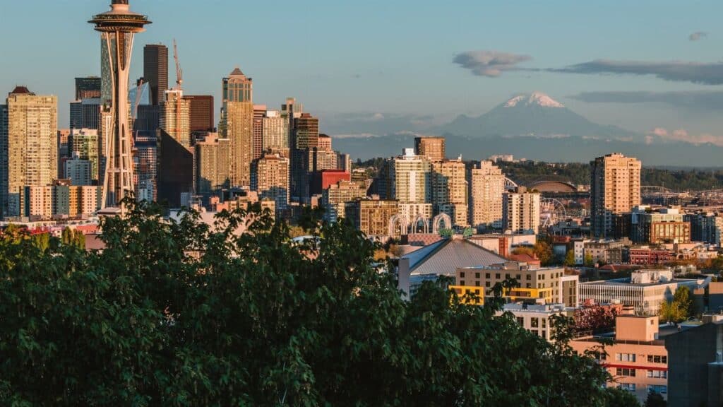 Stunning view of Seattle's iconic skyline featuring the Space Needle and Mount Rainier in the background.