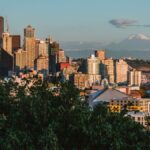 Stunning view of Seattle's iconic skyline featuring the Space Needle and Mount Rainier in the background.