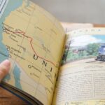 Close-up of a book showing a USA map with West Coast train routes and a train photo.