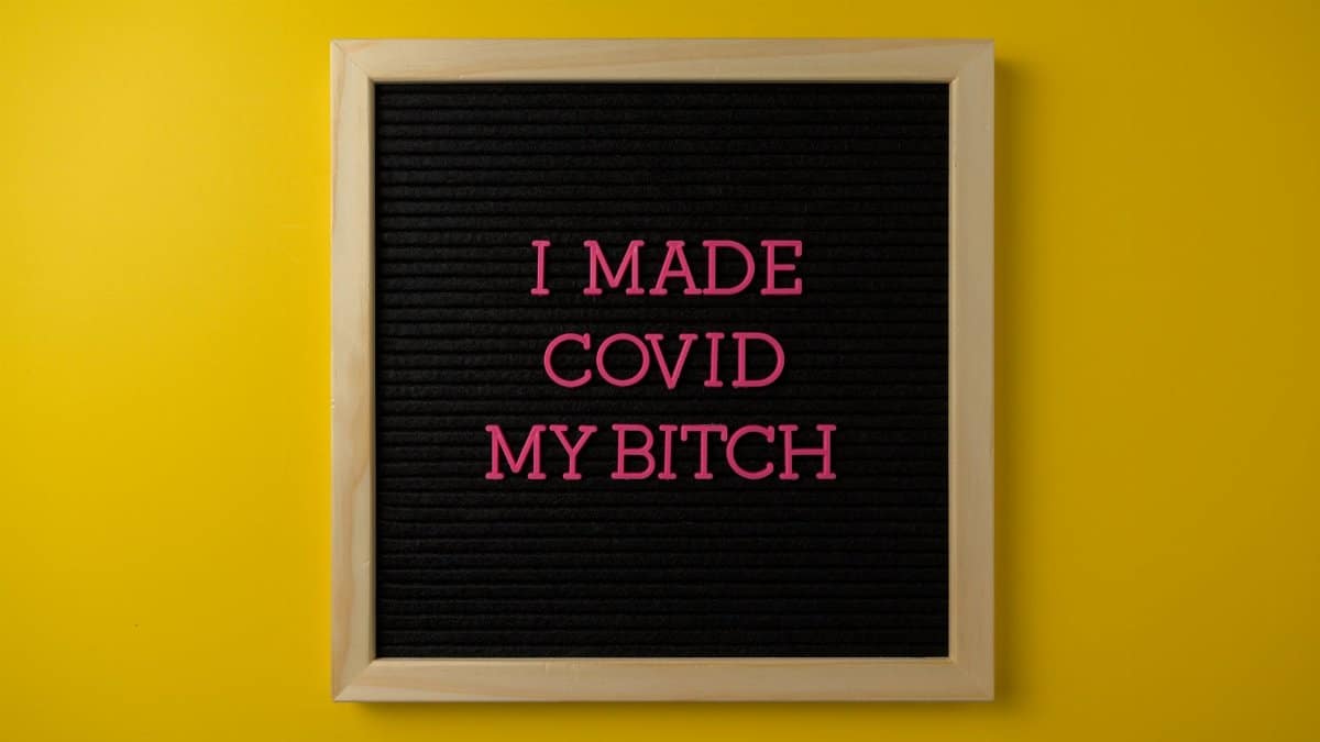 Strong message on a board symbolizing overcoming COVID-19 challenges with vibrant colors.