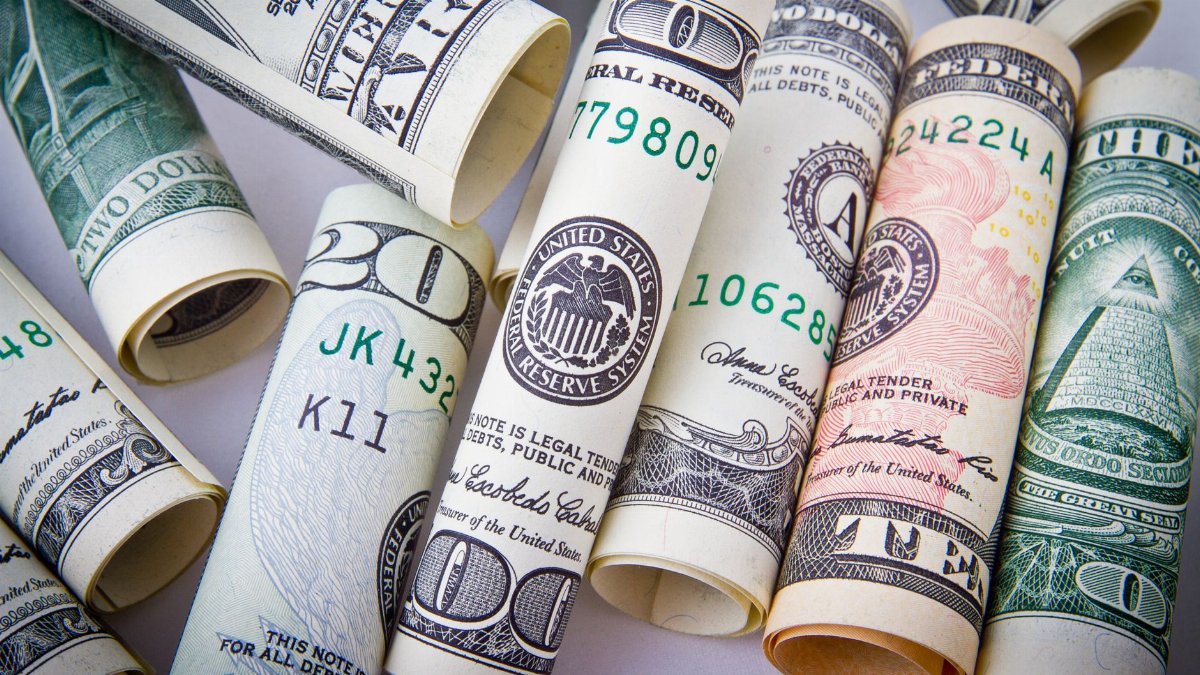 Close-up of rolled US dollar bills symbolizing wealth, financial success, and currency.