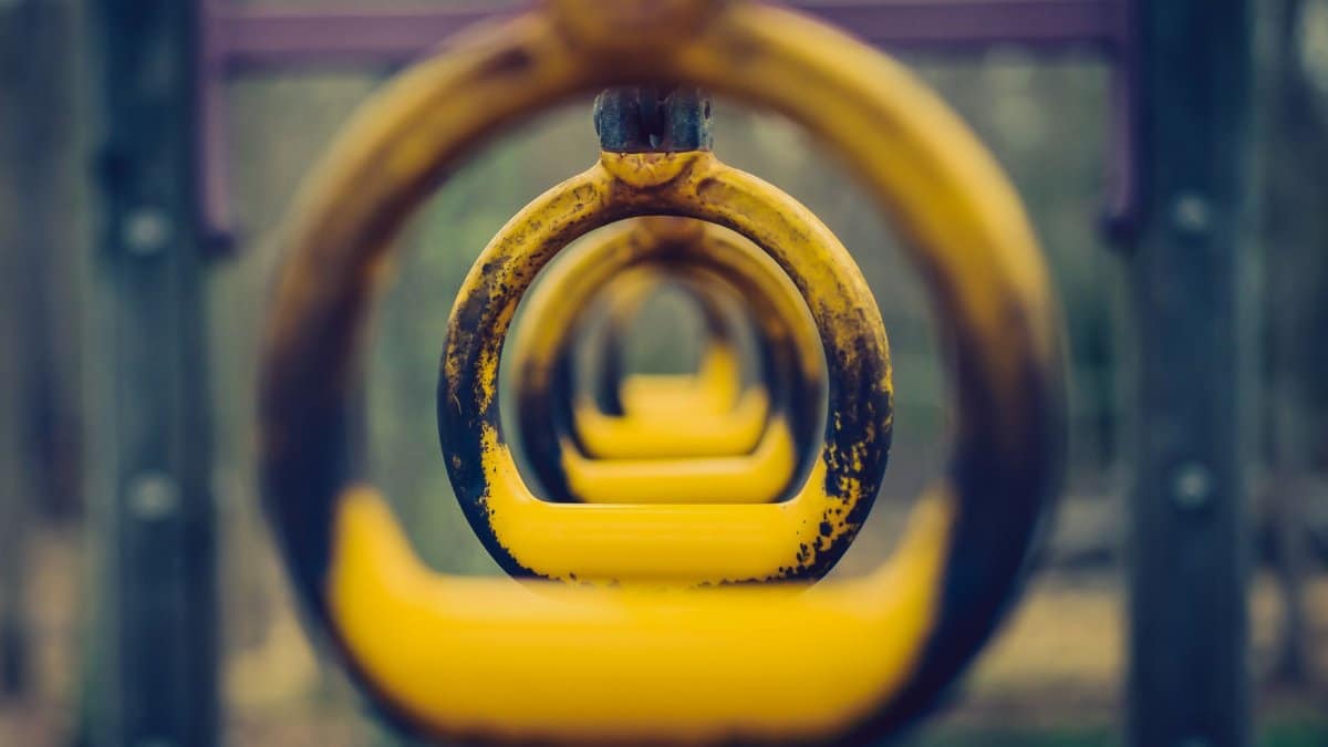 Focused view of yellow playground monkey bars, ideal for fitness and training concepts.
