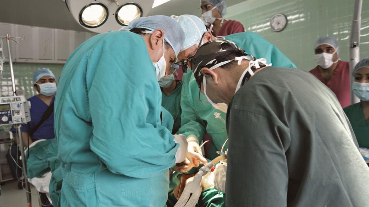 A dedicated surgical team focused on a critical procedure in a bustling operating room.