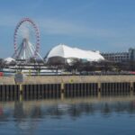 Stunning view of Chicago's Navy Pier featuring the iconic Ferris wheel and waterfront reflection.