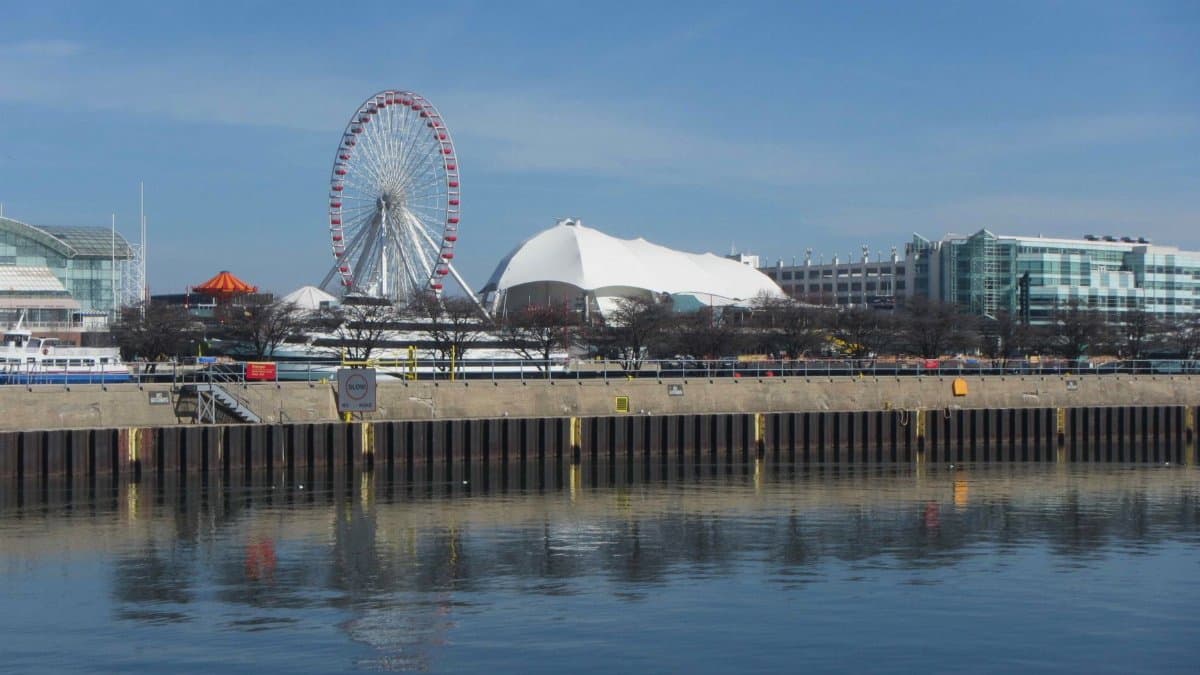 Stunning view of Chicago's Navy Pier featuring the iconic Ferris wheel and waterfront reflection.