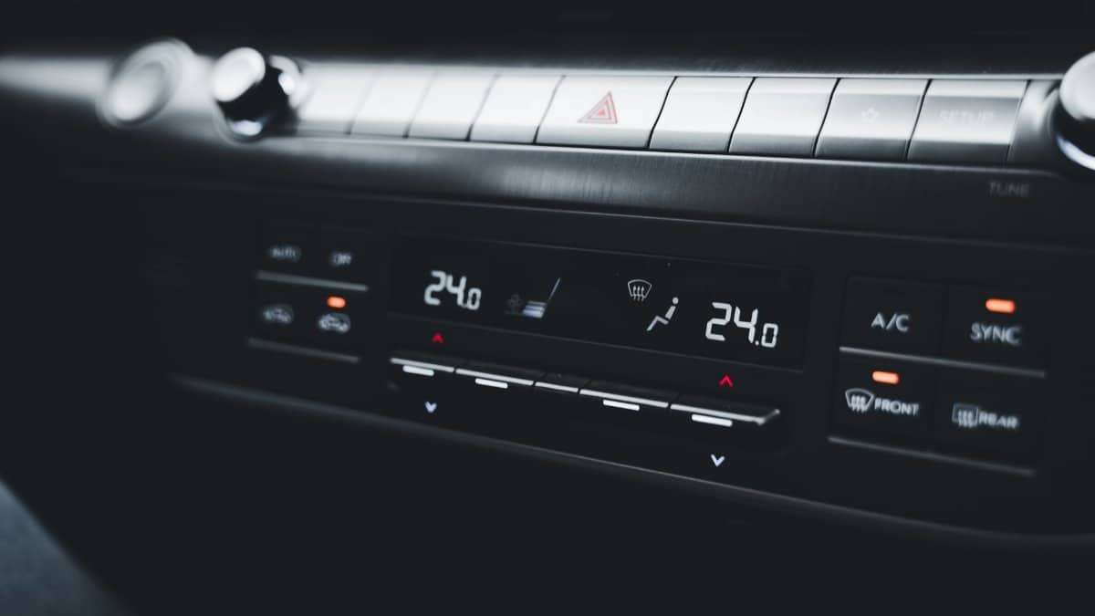 Close-up shot of a car's climate control system displaying temperature settings.