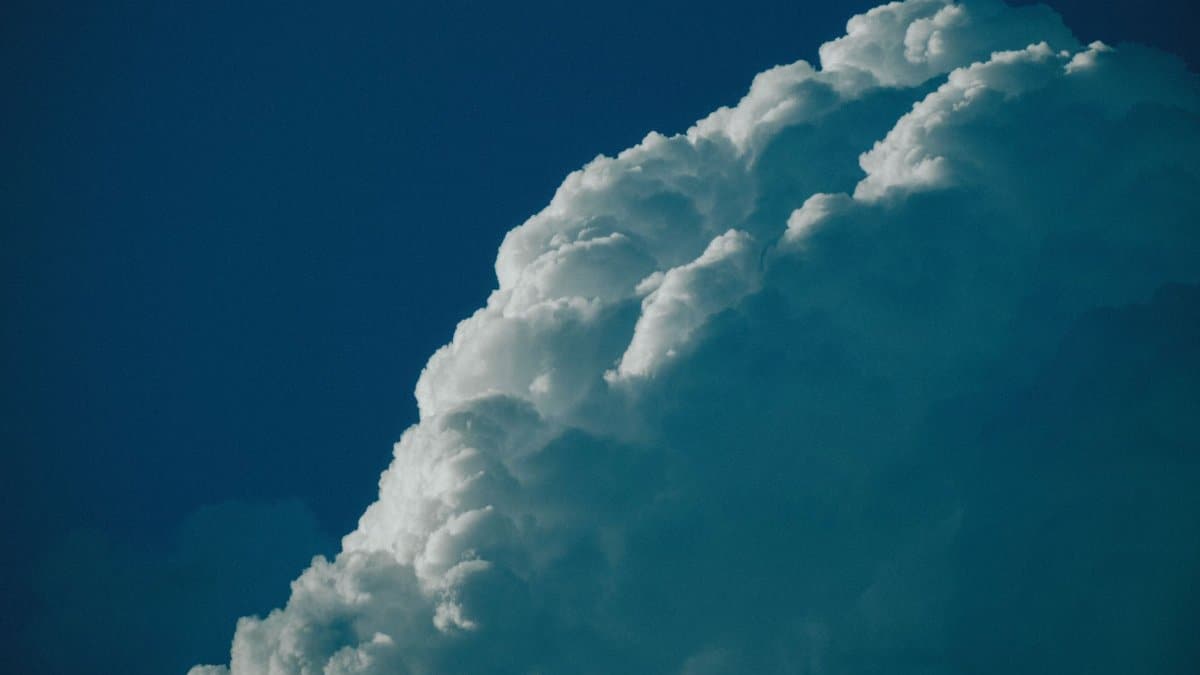 Striking view of cumulus cloud with deep blue sky backdrop, ideal for weather themes.