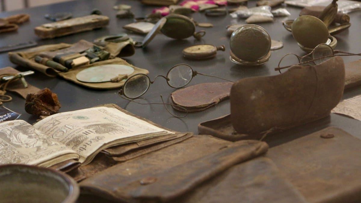 A detailed view of antique artifacts including glasses and documents on display.