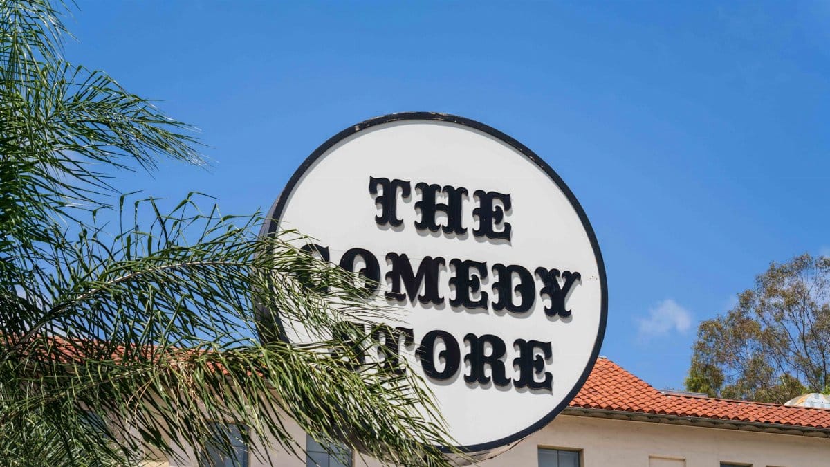The Comedy Store sign with palm trees under a clear blue sky in West Hollywood, California.