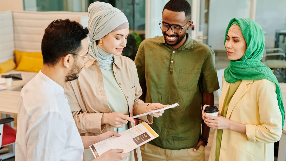 A diverse group of professionals engaged in a collaborative meeting in a modern office setting.