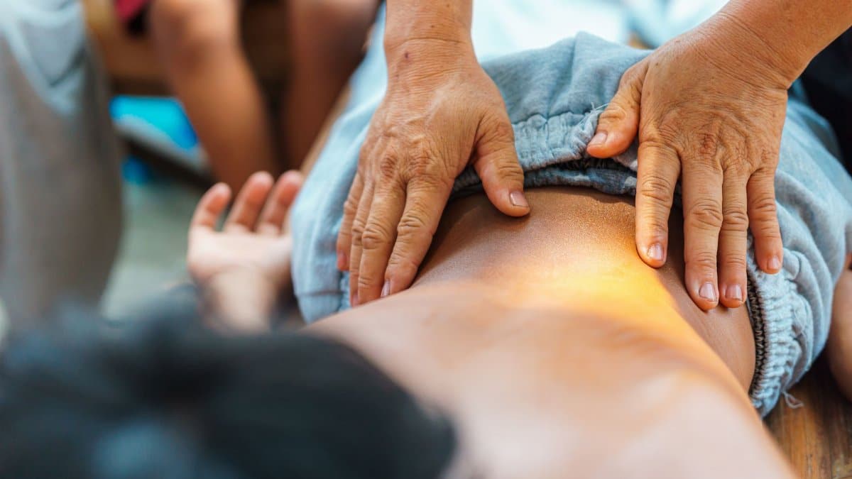 A soothing back massage performed by a therapist outdoors, focusing on relaxation and well-being.