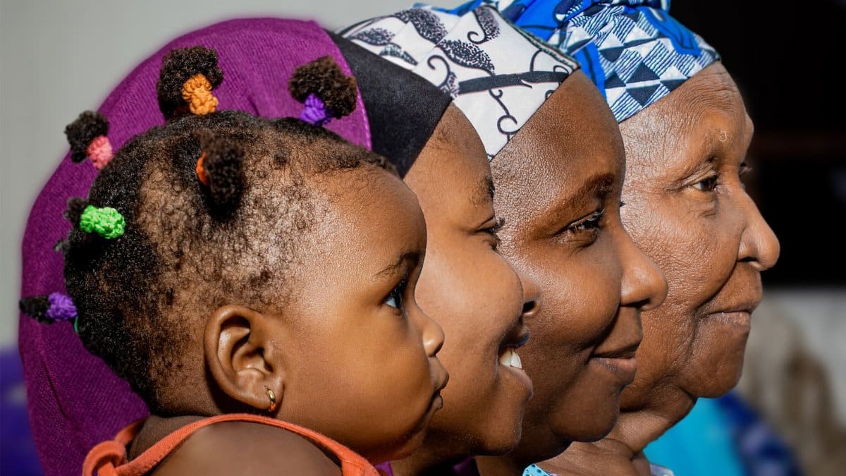 Side profile of four African women spanning different generations.
