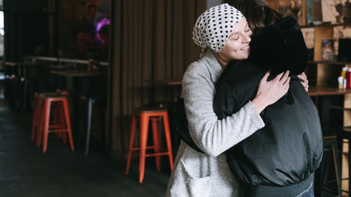 Two individuals sharing an embracing moment, symbolizing support and care.