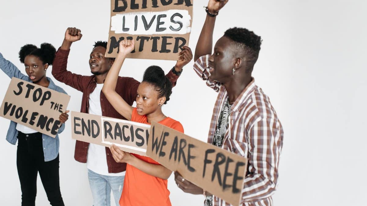 A group of diverse individuals holding signs at a Black Lives Matter protest.