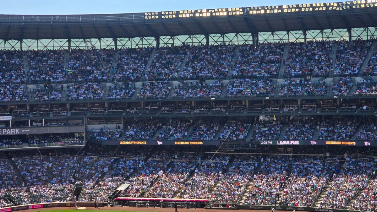 Crowded baseball stadium scene during a sunny day at T-Mobile Park, Seattle.