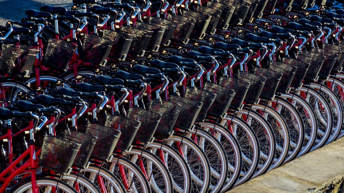 A neat row of red bicycles parked in Stockholm ready for cyclists.