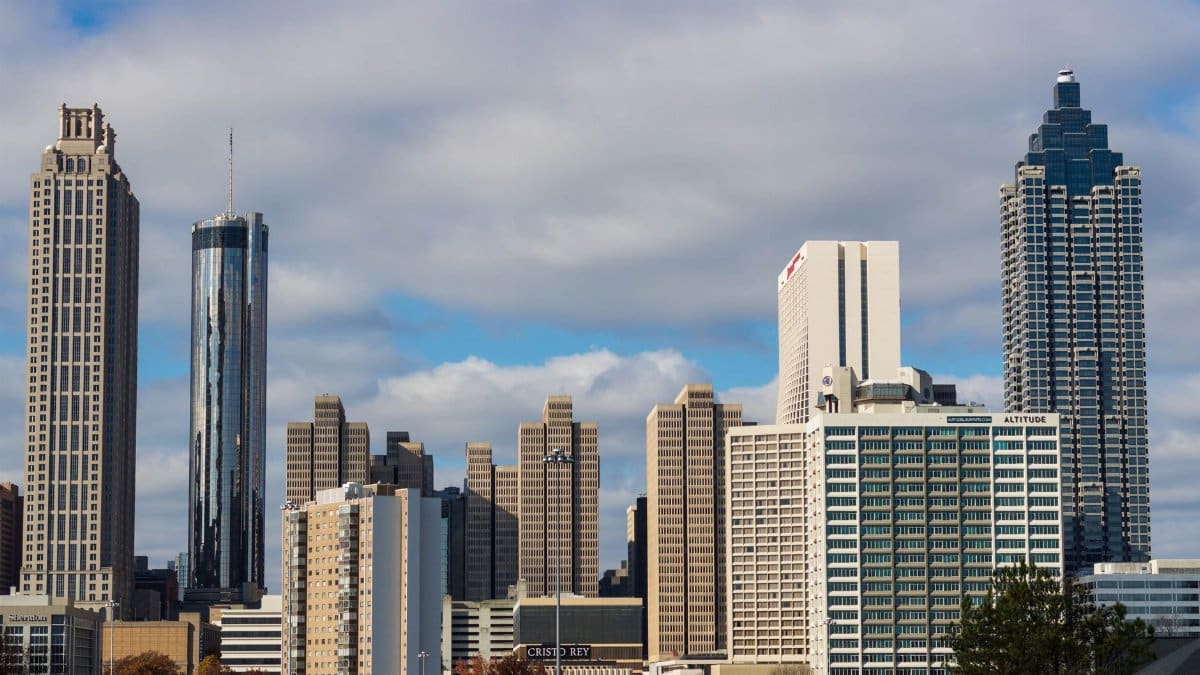 A breathtaking view of Atlanta's skyline featuring iconic skyscrapers under a blue sky.