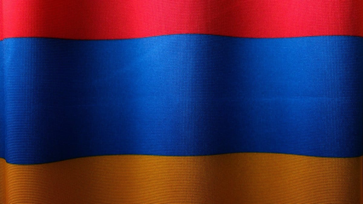 Close-up of the colorful Armenian flag with red, blue, and orange stripes symbolizing national pride.