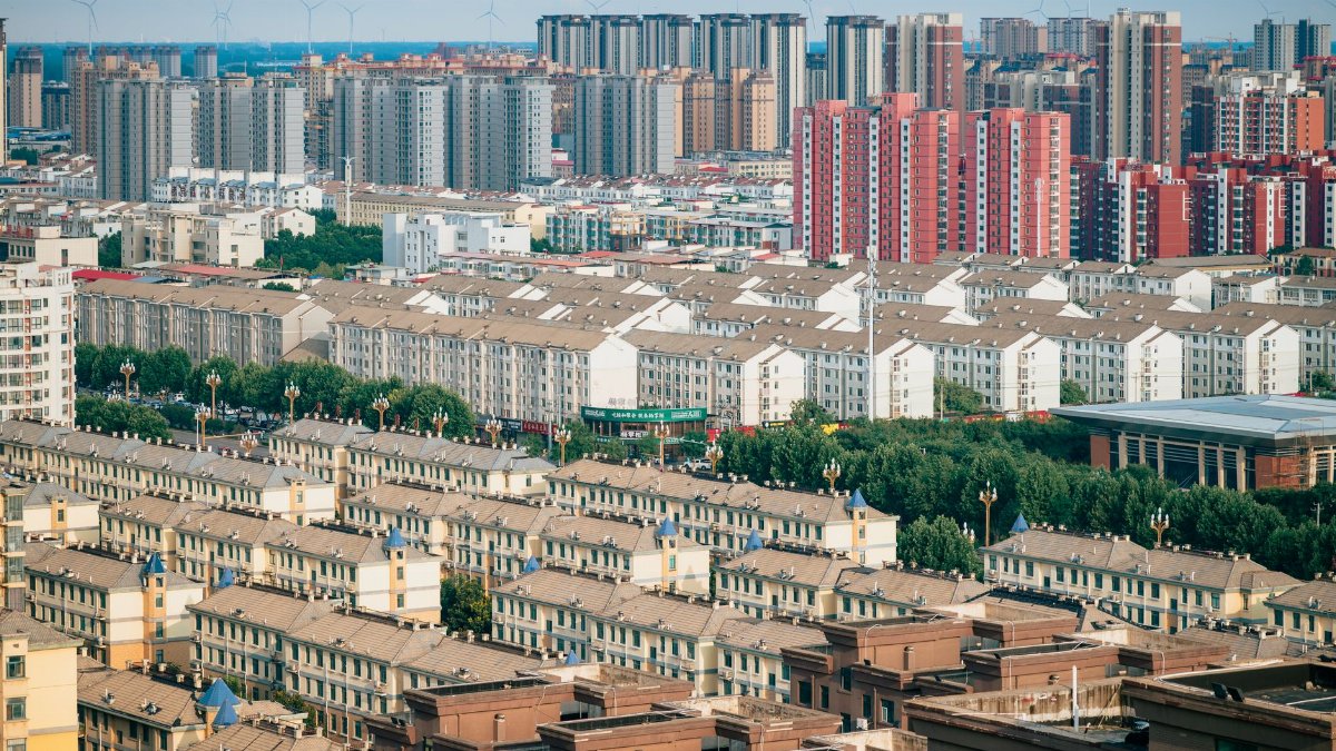 Aerial view of urban skyline with residential and high-rise buildings.