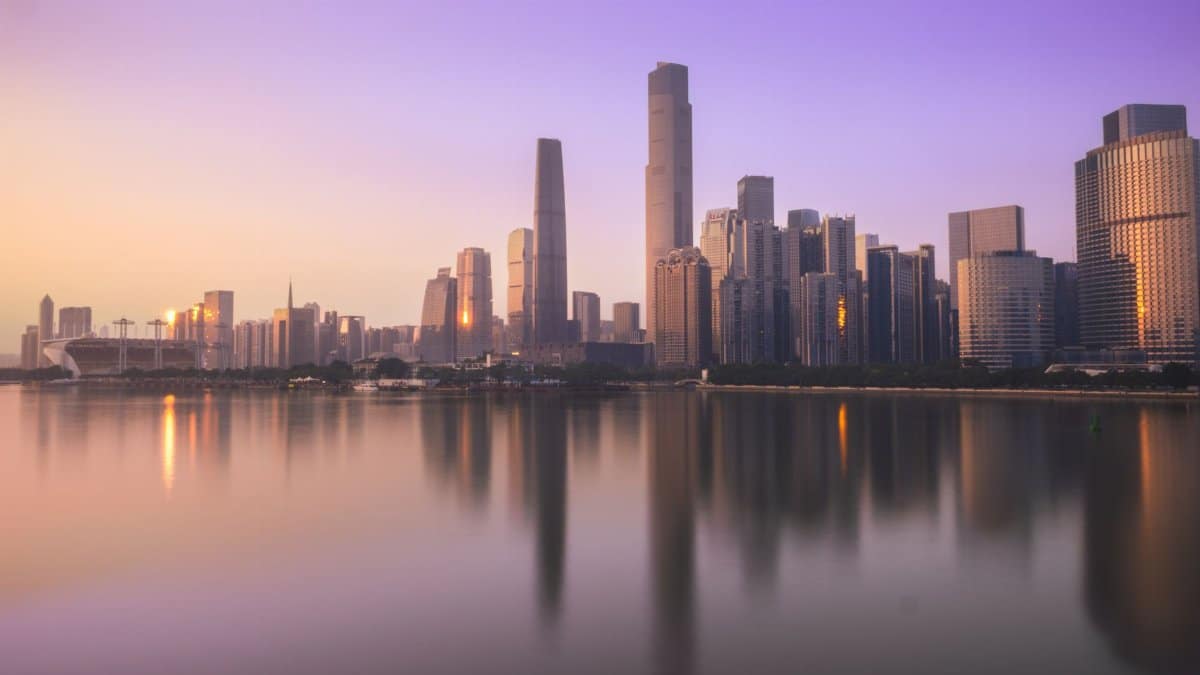 Stunning view of Guangzhou's skyline at sunset, capturing skyscrapers reflecting on the Pearl River.