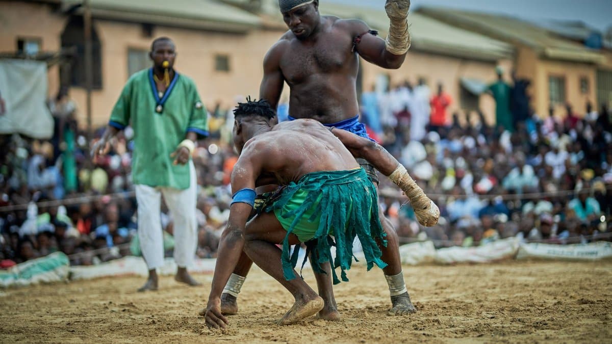 Intense traditional wrestling match in a crowded outdoor arena capturing cultural sportsmanship.
