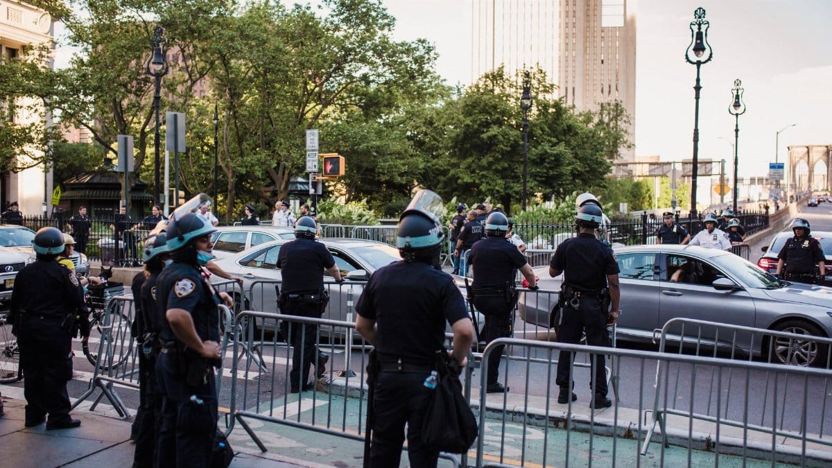 Law enforcement officers manage traffic and crowd control in urban city setting.
