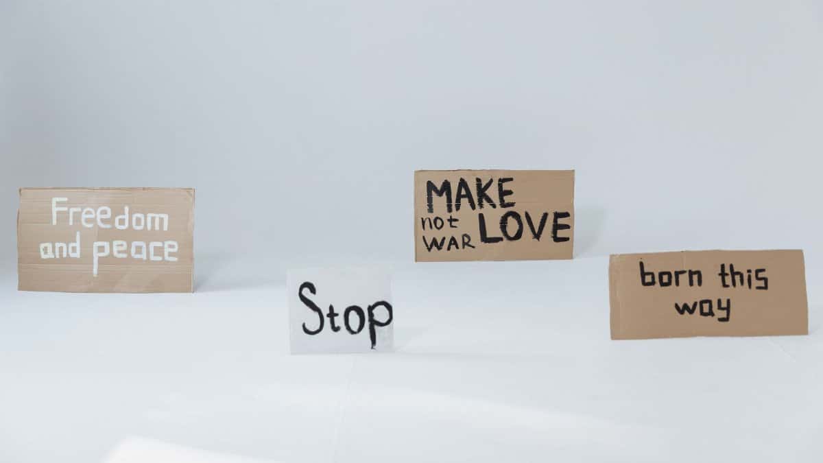 Cardboard signs promoting peace, love, and acceptance, perfect for activism and social movements.