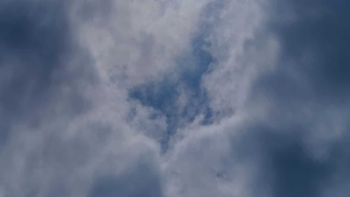 A captivating view of dramatic clouds with blue sky peeking through, creating a serene atmosphere.