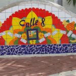 Vibrant mosaic mural in Little Havana, Miami featuring Calle 8 with colorful fruits and dominoes.