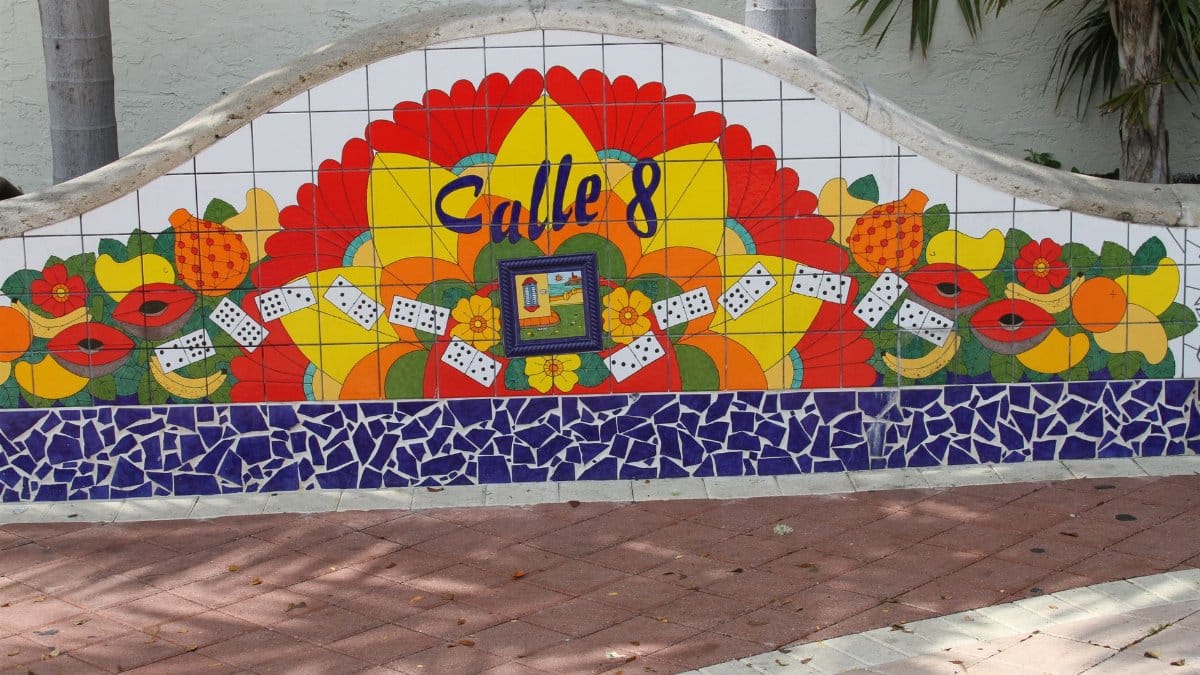 Vibrant mosaic mural in Little Havana, Miami featuring Calle 8 with colorful fruits and dominoes.