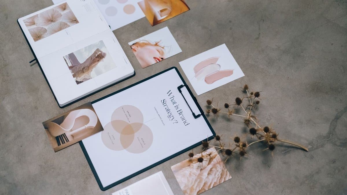 A modern flat lay of branding strategy documents and design elements on a desk.