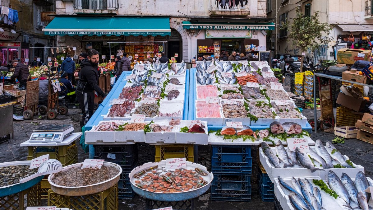 Colorful fish market in Campania, Italy, showcasing fresh seafood variety on display.
