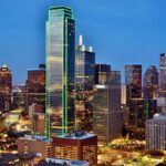 Stunning view of the Dallas skyline at night with illuminated skyscrapers and city lights.
