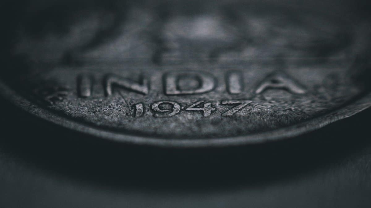 Close-up of a vintage Indian coin dated 1947, showcasing intricate details and texture.