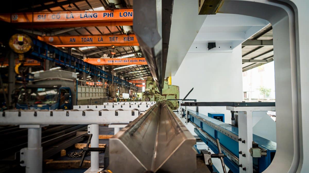 Interior view of an industrial building featuring machinery and metal conveyor systems.