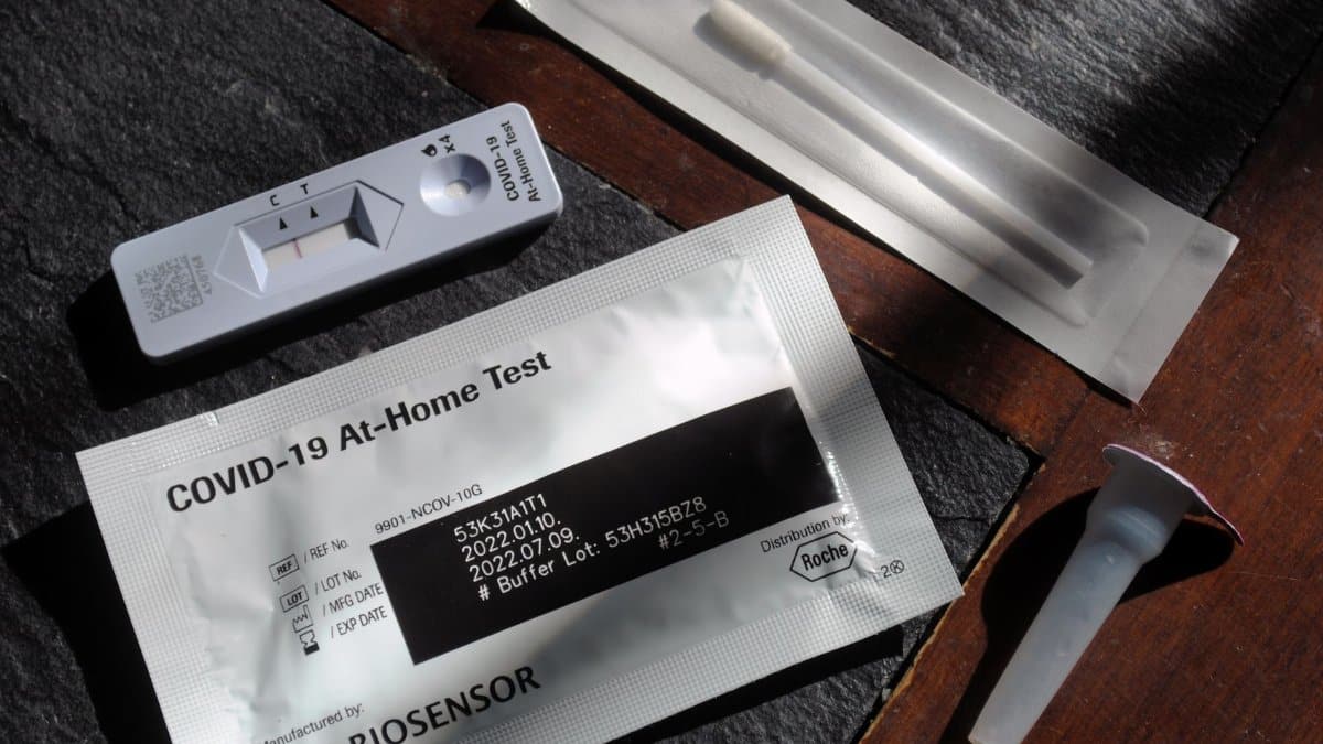 Close-up of a COVID-19 at-home test kit with packaging and test components displayed.