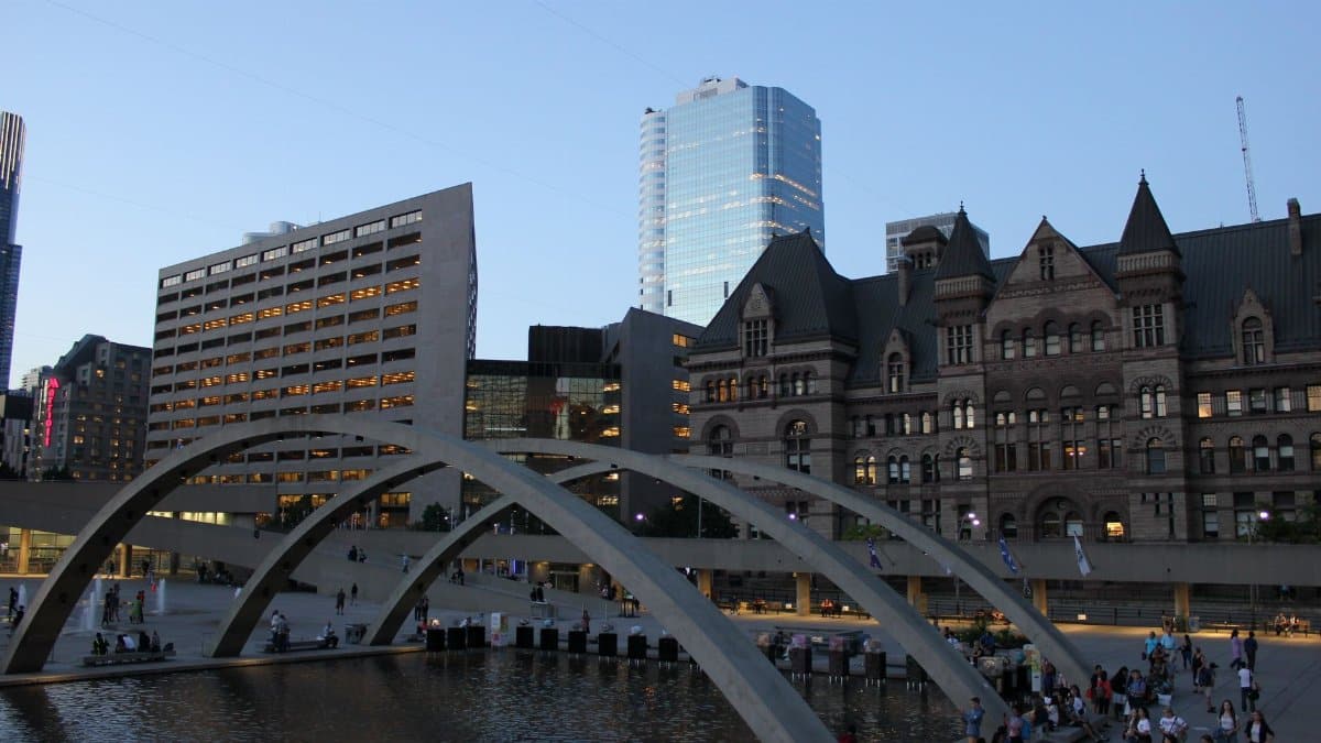Capture of Nathan Phillips Square with arched bridge and cityscape in Toronto, Ontario.