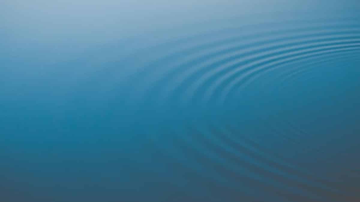 A tranquil image of blue water with gentle ripples creating a soothing pattern.