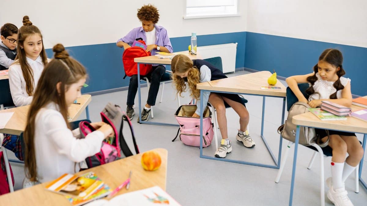 Young students in a classroom engaging in morning preparations, illustrating diversity and education.
