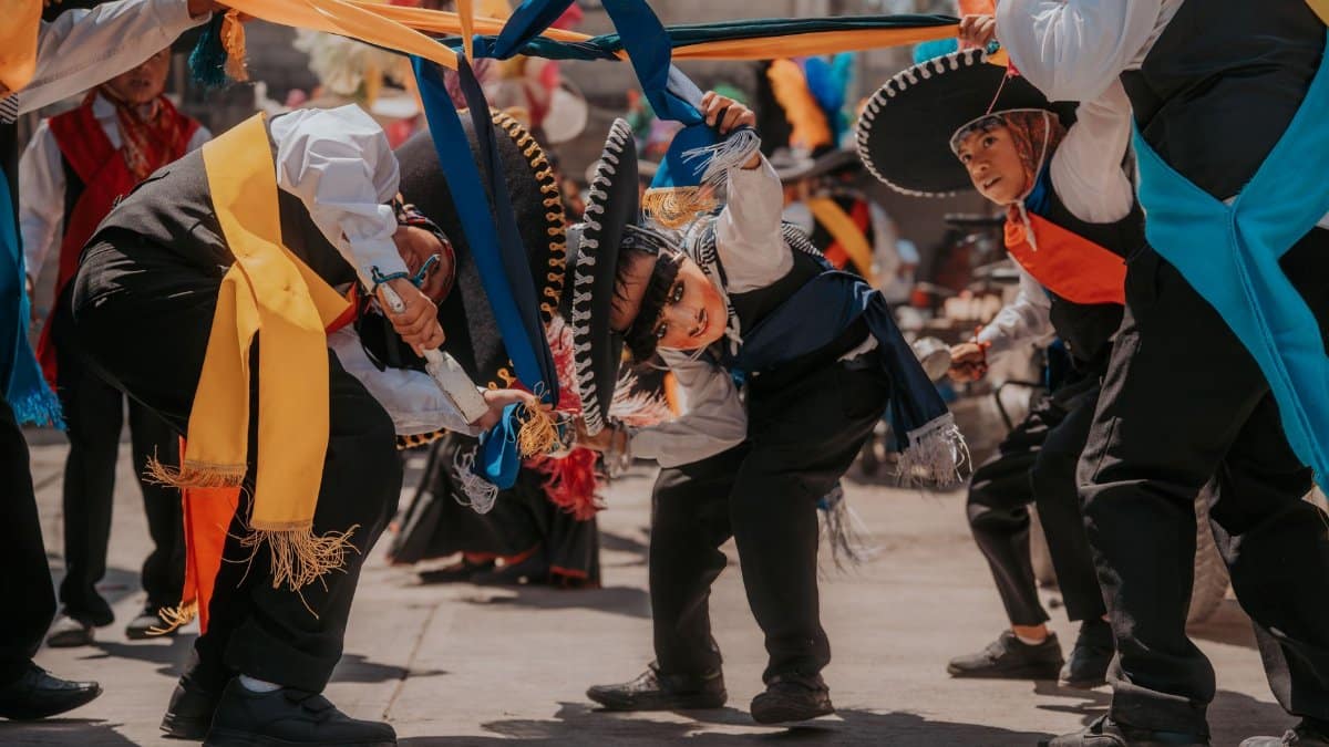 Colorful cultural dance performance in Puebla, Mexico showcasing traditional attire and music.