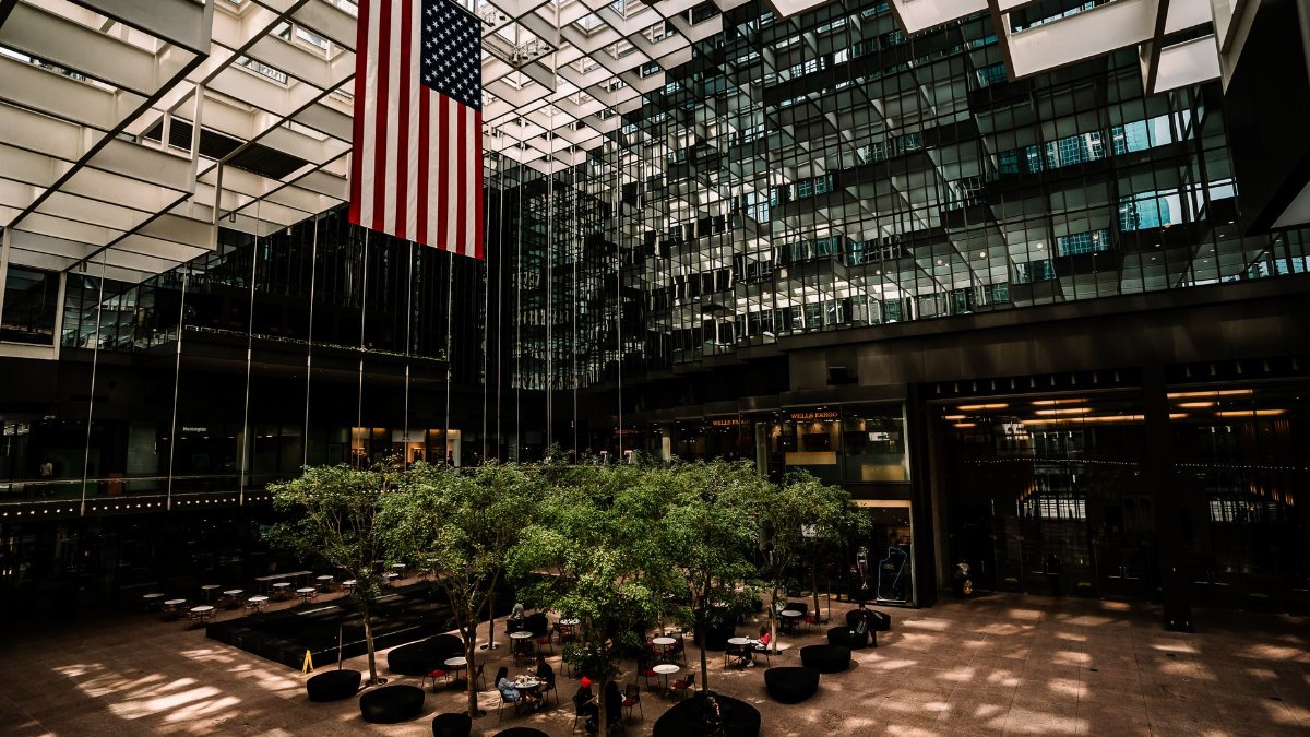 Spacious modern atrium in Minneapolis with American flag, architecture and natural light.