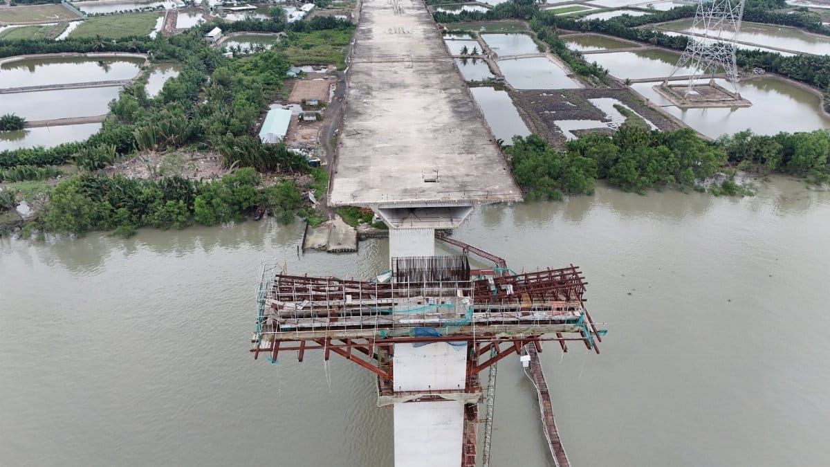 Aerial view of an unfinished bridge stretching over a river in Ho Chi Minh City, Vietnam.
