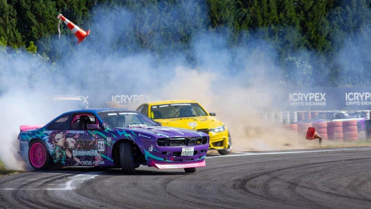 Dynamic drift car race with vivid colors and smoke on a sunny track, showcasing speed and style.