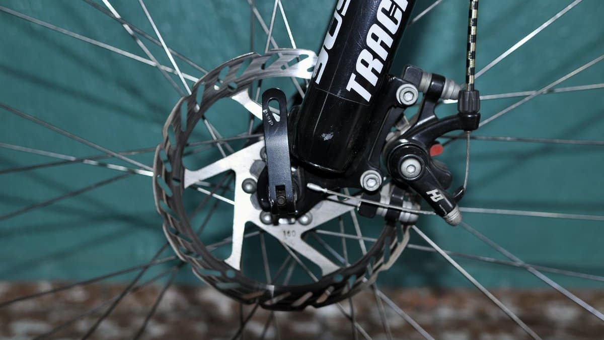 Detailed view of a bicycle disc brake system showing the rotor and caliper mechanism.