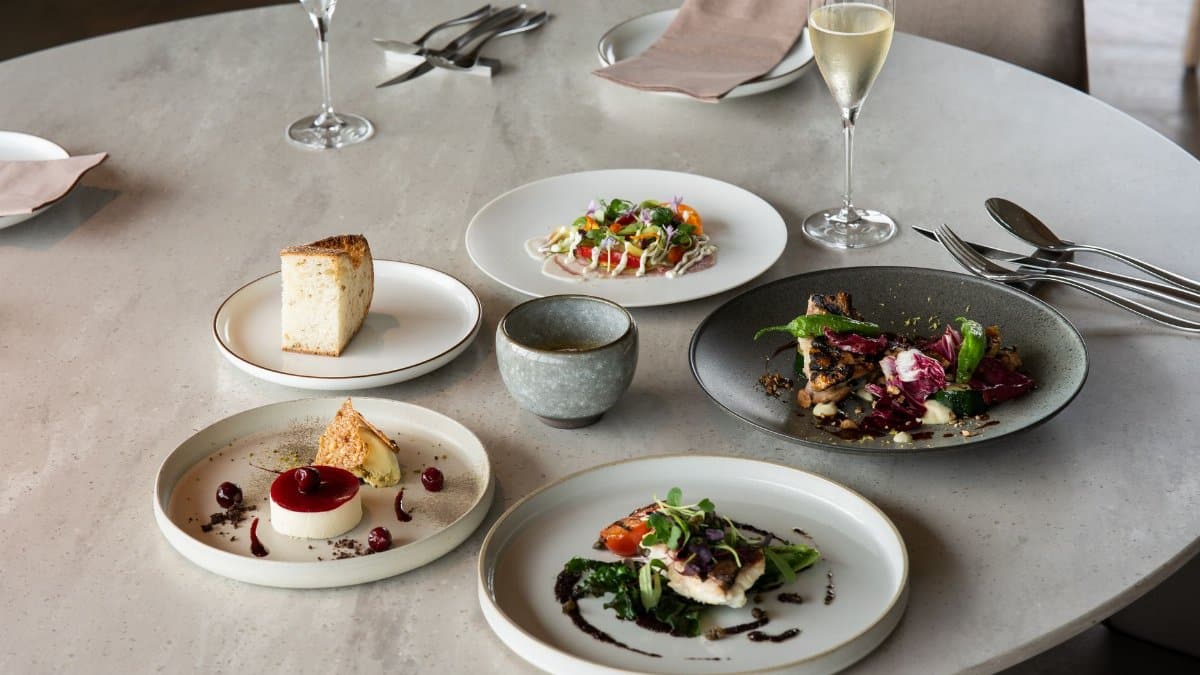 Elegant fine dining setup with gourmet dishes and wine in Tokyo, Japan.