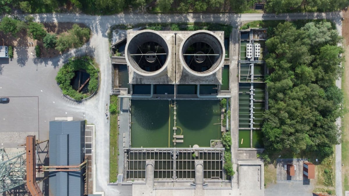Aerial view of industrial water treatment facility surrounded by greenery in Bochum, Germany.