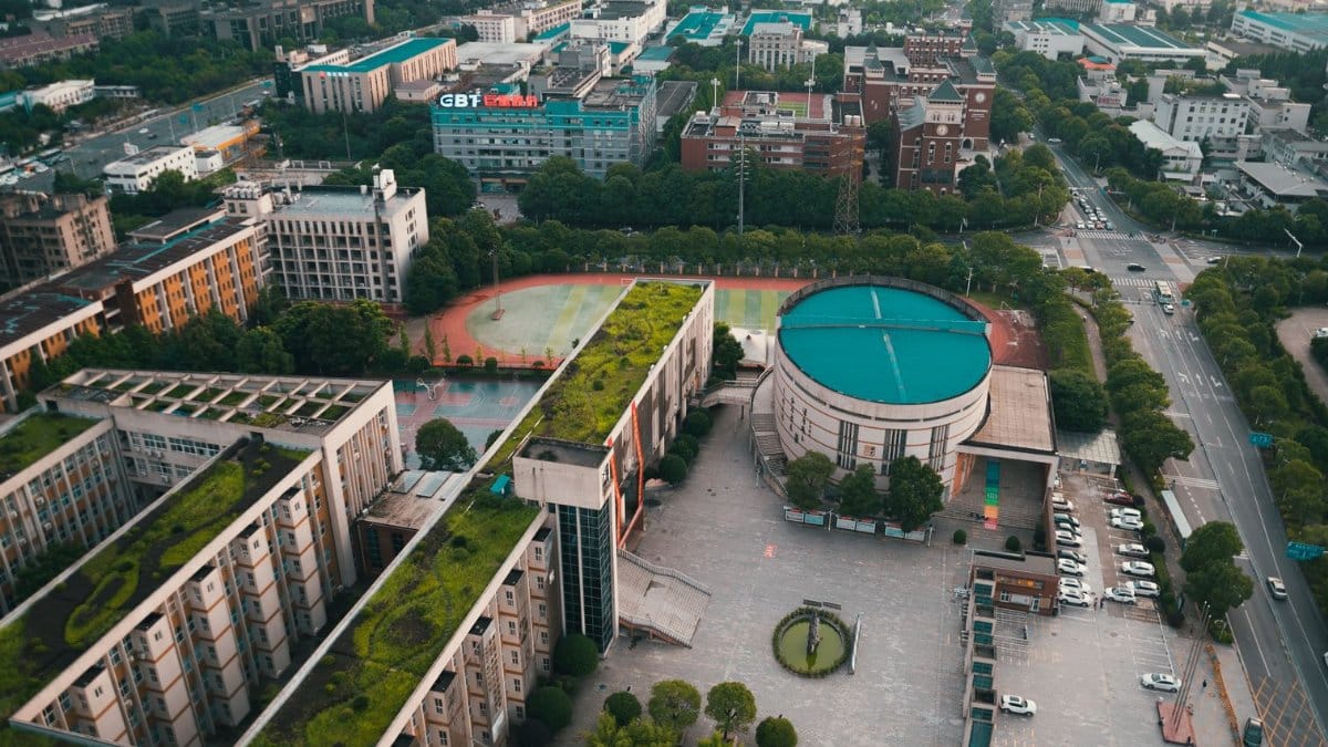 Aerial view of a vibrant urban landscape, showcasing modern architecture and green rooftops.