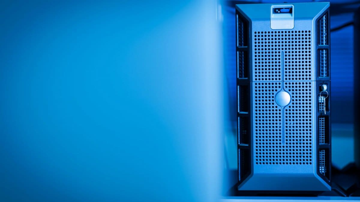 Close-up of a modern server unit in a blue-lit data center environment.